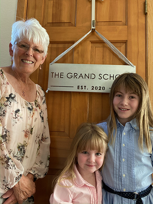 Suzanne Barchers with two grandkids at the beginning of a year of COVID homeschooling